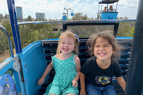 Isla 3 and Ivy 3 of San Elijo Hills share giggles on the Skyfari Aerial Tram at San Diego Zoo